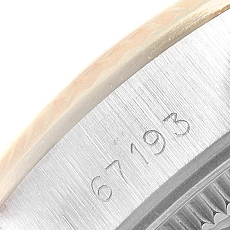 The image shows a close-up of the side of the Rolex Oyster Perpetual 67193 Women's Steel and Gold (two tone) Champagne Dial 67193 Women's Steel and Gold (two tone) Champagne Dial watch, highlighting the engraved serial number "67193."