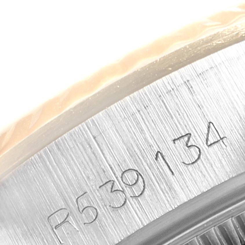 This close-up image shows the engraved serial number on the bezel edge of a Rolex Oyster Perpetual 67193 Women's Steel and Gold (two tone) Champagne Dial 67193 Women's Steel and Gold (two tone) Champagne Dial watch.