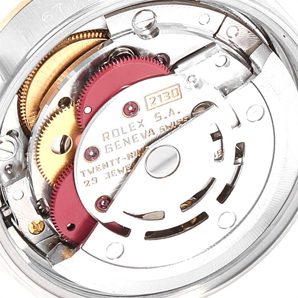 This close-up image shows the intricate inner mechanism of a Rolex Oyster Perpetual 67193 Women's Steel and Gold (two tone) Champagne Dial 67193 Women's Steel and Gold (two tone) Champagne Dial watch model.