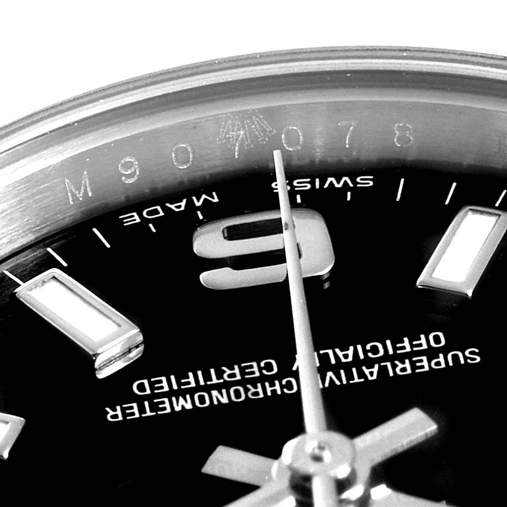 This image shows a close-up of the dial and bezel of a Rolex Oyster Perpetual 176200 Women
s Stainless Steel Black Dial 176200 Women
s Stainless Steel Black Dial watch, highlighting the number "9" and "Swiss Made" text.