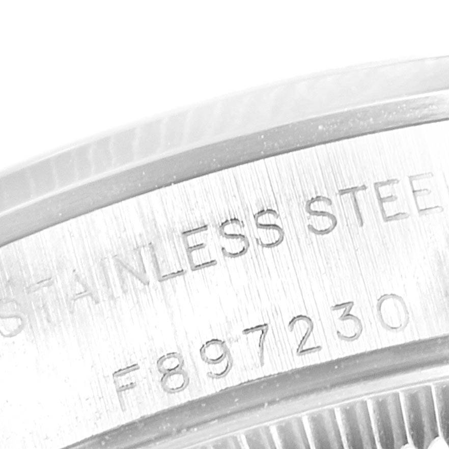 This image shows a close-up view of the stainless steel case back and serial number of a Rolex Oyster Perpetual 76080 Women's Stainless Steel Pink Dial 76080 Women's Stainless Steel Pink Dial watch.