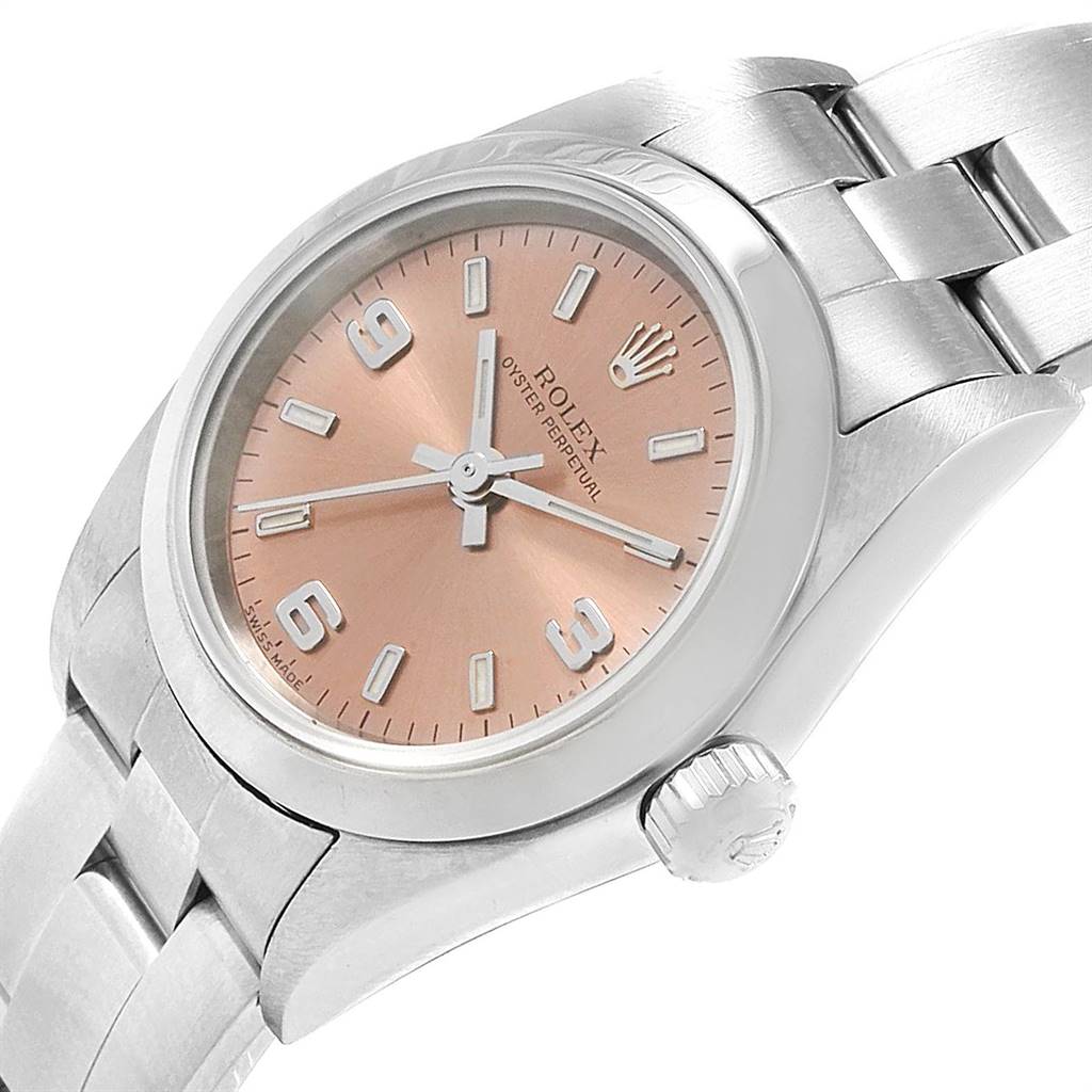 This image features a Rolex Oyster Perpetual 76080 Women's Stainless Steel Pink Dial 76080 Women's Stainless Steel Pink Dial watch, showcasing a close-up of the dial, bezel, case, crown, and part of the bracelet at an oblique angle.