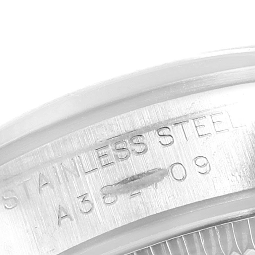 This close-up image shows a portion of the case back of the Rolex Oyster Perpetual 76080 Women
s Stainless Steel White Dial 76080 Women
s Stainless Steel White Dial watch, highlighting the “STAINLESS STEEL” engraving.