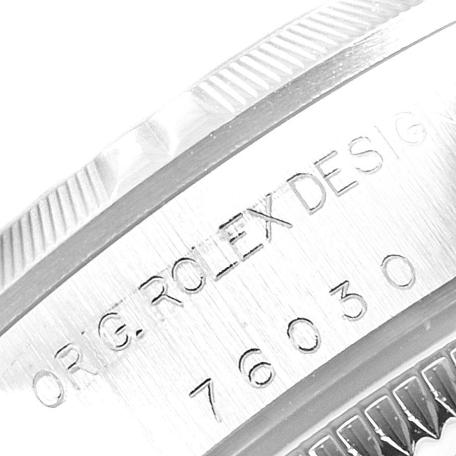 This close-up image shows the engraved edge and bezel of a Rolex Oyster Perpetual 76030 Women's Stainless Steel Black Dial 76030 Women's Stainless Steel Black Dial watch.
