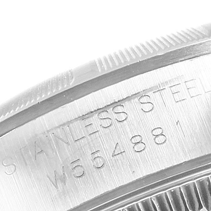 This image shows a close-up of the side of an Oyster Perpetual model by Rolex, displaying the serial number engraved on the stainless steel.