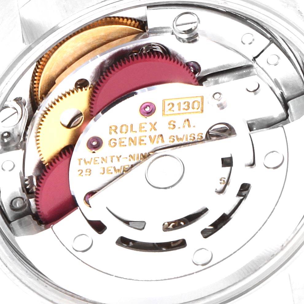 This image shows the intricate internal mechanism of a Rolex Oyster Perpetual 67230 Women's Stainless Steel Pink Dial 67230 Women's Stainless Steel Pink Dial watch, highlighting gears and the movement.