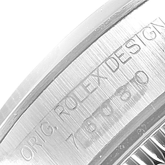 This image shows a close-up view of the engraved inner bezel of a Rolex Oyster Perpetual 76080 Women's Stainless Steel Pink Dial 76080 Women's Stainless Steel Pink Dial watch.