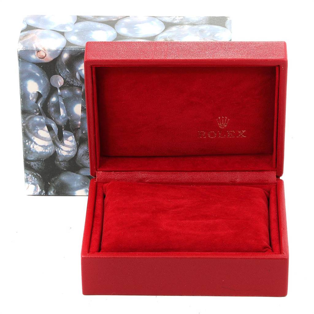 This image shows an open red Rolex watch box for the Oyster Perpetual model, with red cushioning inside and a Rolex-branded outer box.