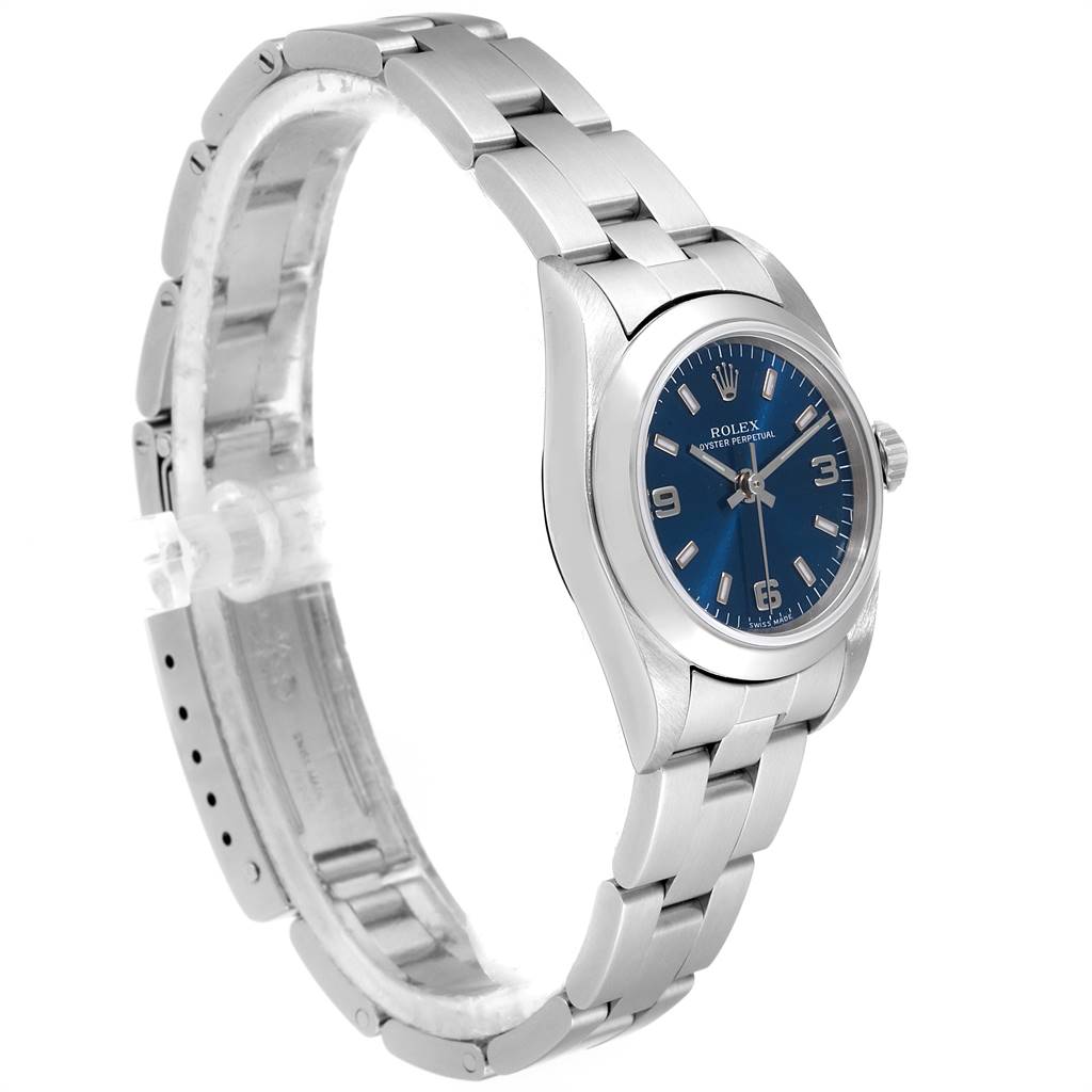 The image shows a side angle of a Rolex Oyster Perpetual 76080 Women
s Stainless Steel Blue Dial 76080 Women
s Stainless Steel Blue Dial watch with a blue dial and stainless steel bracelet.