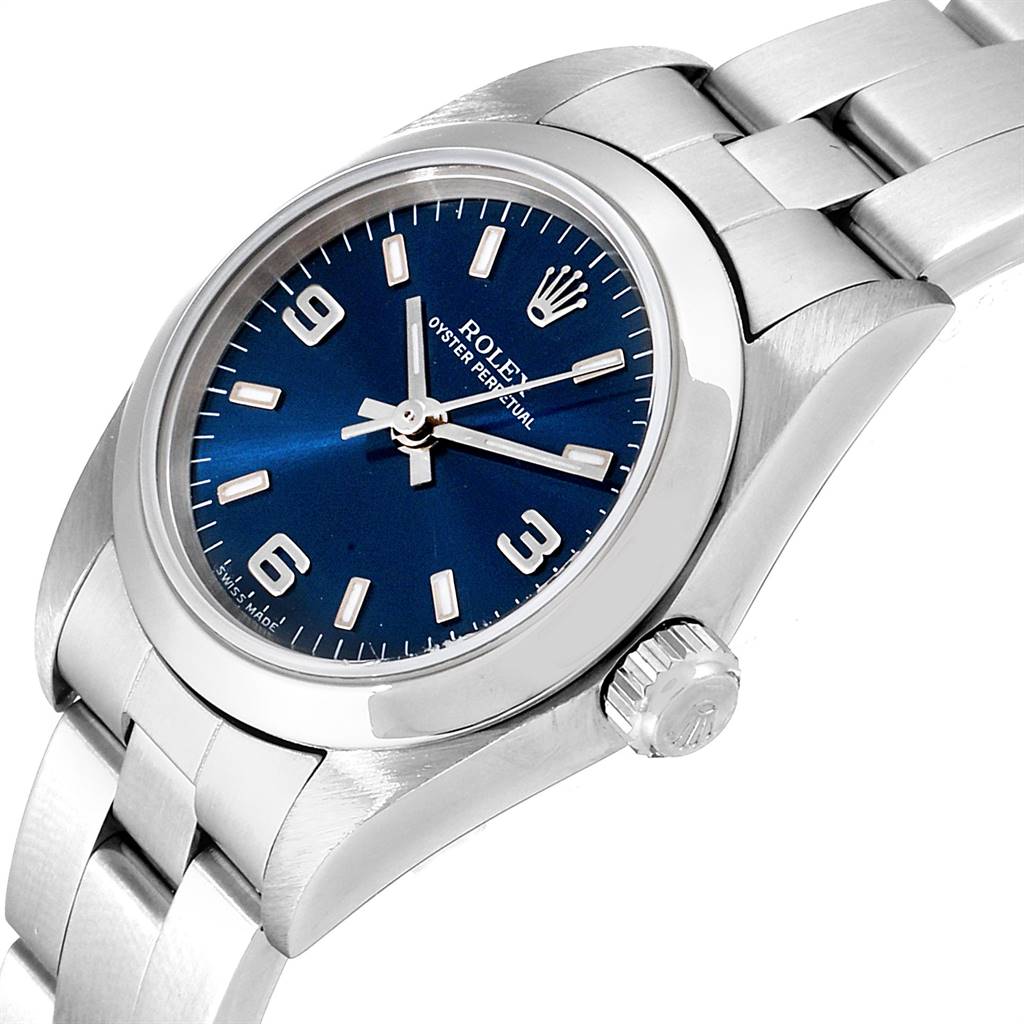 This image displays a close-up view of a Rolex Oyster Perpetual 76080 Women
s Stainless Steel Blue Dial 76080 Women
s Stainless Steel Blue Dial watch, showcasing the face, crown, and part of the bracelet at an angle.