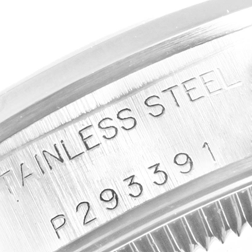 This image shows a close-up of the serial number and "Stainless Steel" engraving on the case back of a Rolex Oyster Perpetual 76080 Women
s Stainless Steel Blue Dial 76080 Women
s Stainless Steel Blue Dial watch.