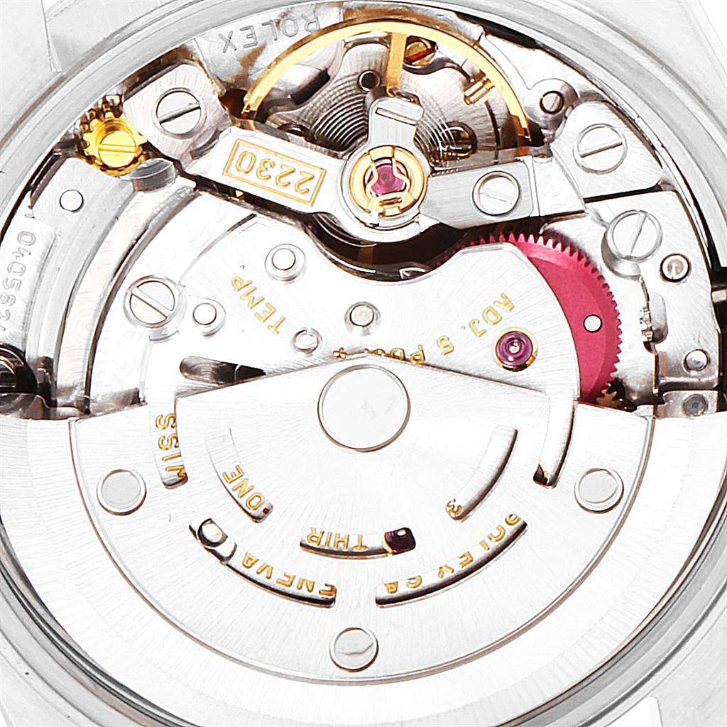 This is a close-up of the movement of a Rolex Oyster Perpetual 76080 Women
s Stainless Steel Blue Dial 76080 Women
s Stainless Steel Blue Dial watch, showing intricate gear and rotor details.