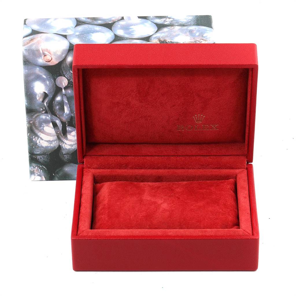 This image shows a red Rolex watch box for the Oyster Perpetual model, with the interior lined in red suede.