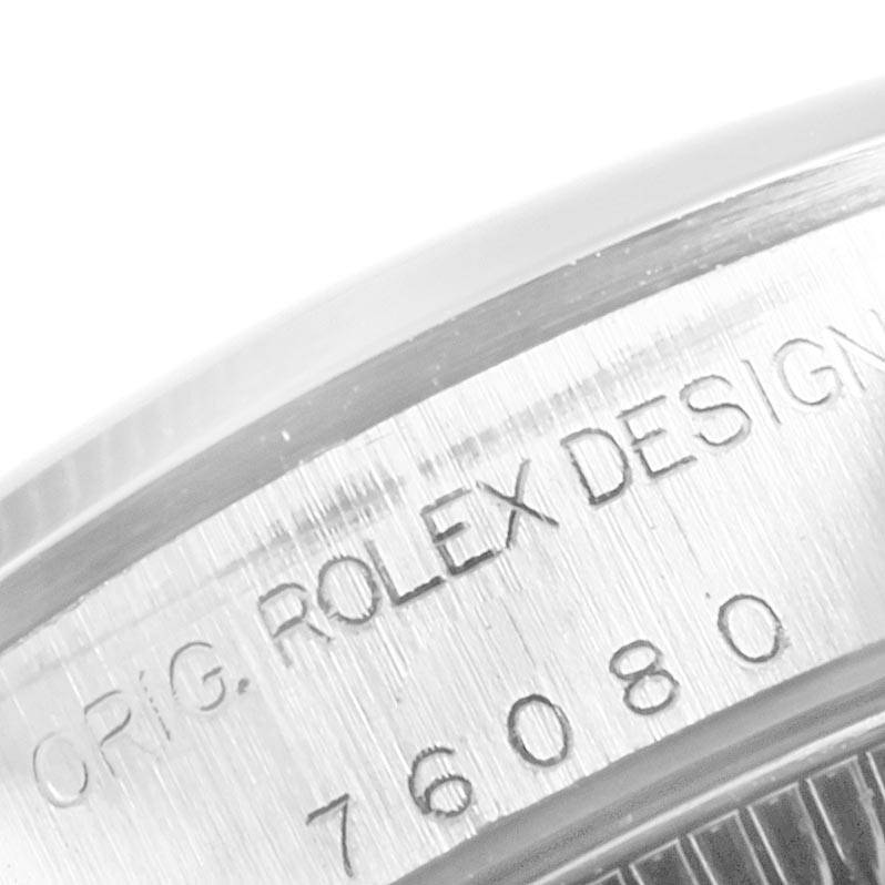 This close-up image showcases the engraved model details on the side of the case of a Rolex Oyster Perpetual 76080 Women's Stainless Steel Pink Dial 76080 Women's Stainless Steel Pink Dial watch.