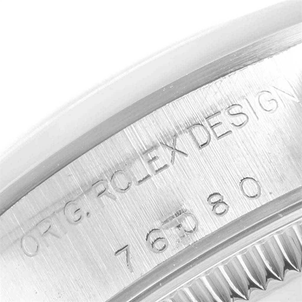 This image shows a close-up angle of the engraved case side of the Rolex Oyster Perpetual 76080 Women's Stainless Steel Black Dial 76080 Women's Stainless Steel Black Dial watch.