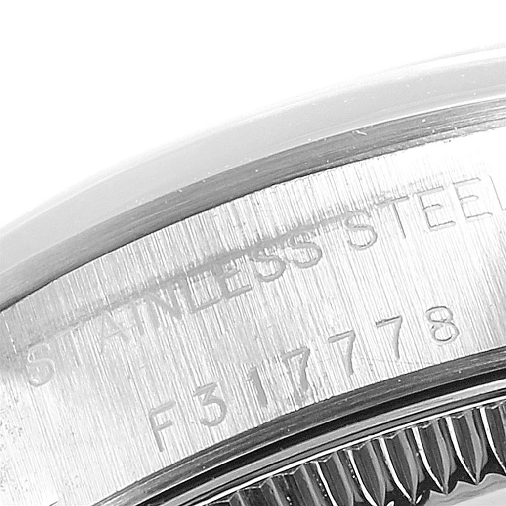 This close-up shows the side engraving on the case of a Rolex Oyster Perpetual 76080 Women's Stainless Steel Black Dial 76080 Women's Stainless Steel Black Dial watch, highlighting the stainless steel and serial number.