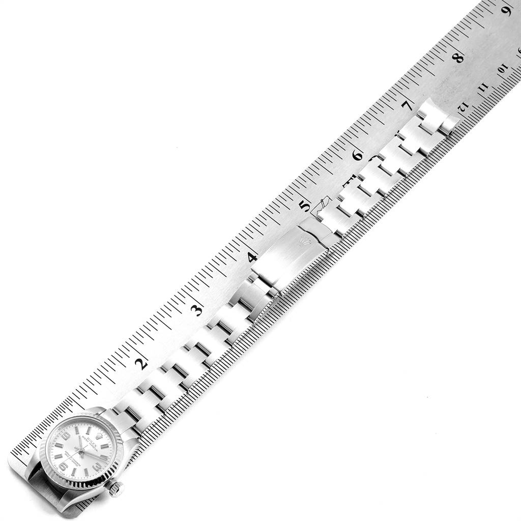 The Rolex Oyster Perpetual 176234 Women's Stainless Steel Silver Dial 176234 Women's Stainless Steel Silver Dial watch is shown from a top-down angle, featuring its face, crown, and band next to a ruler.