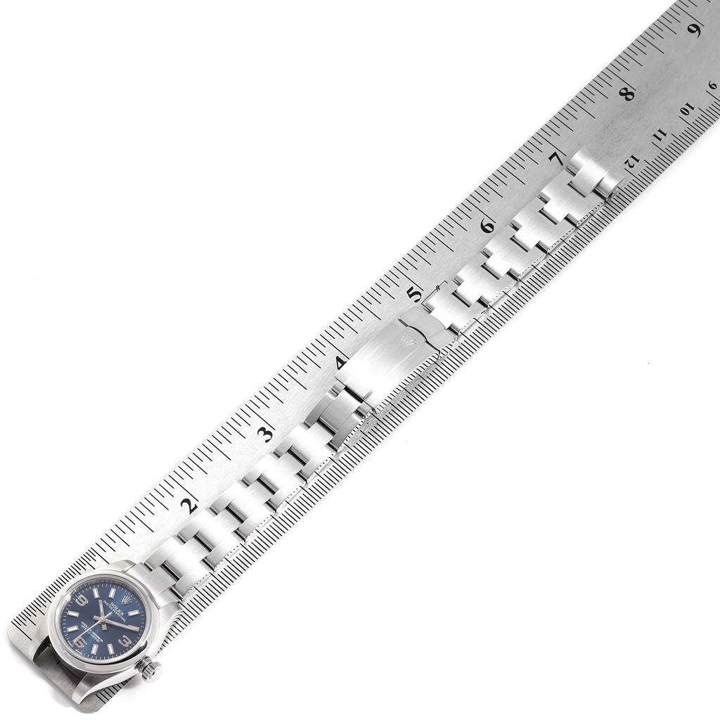 The image shows a Rolex Oyster Perpetual 176200 Women's Stainless Steel Blue Dial 176200 Women's Stainless Steel Blue Dial watch placed next to a ruler, displaying its bracelet and dial from a top-down angle.
