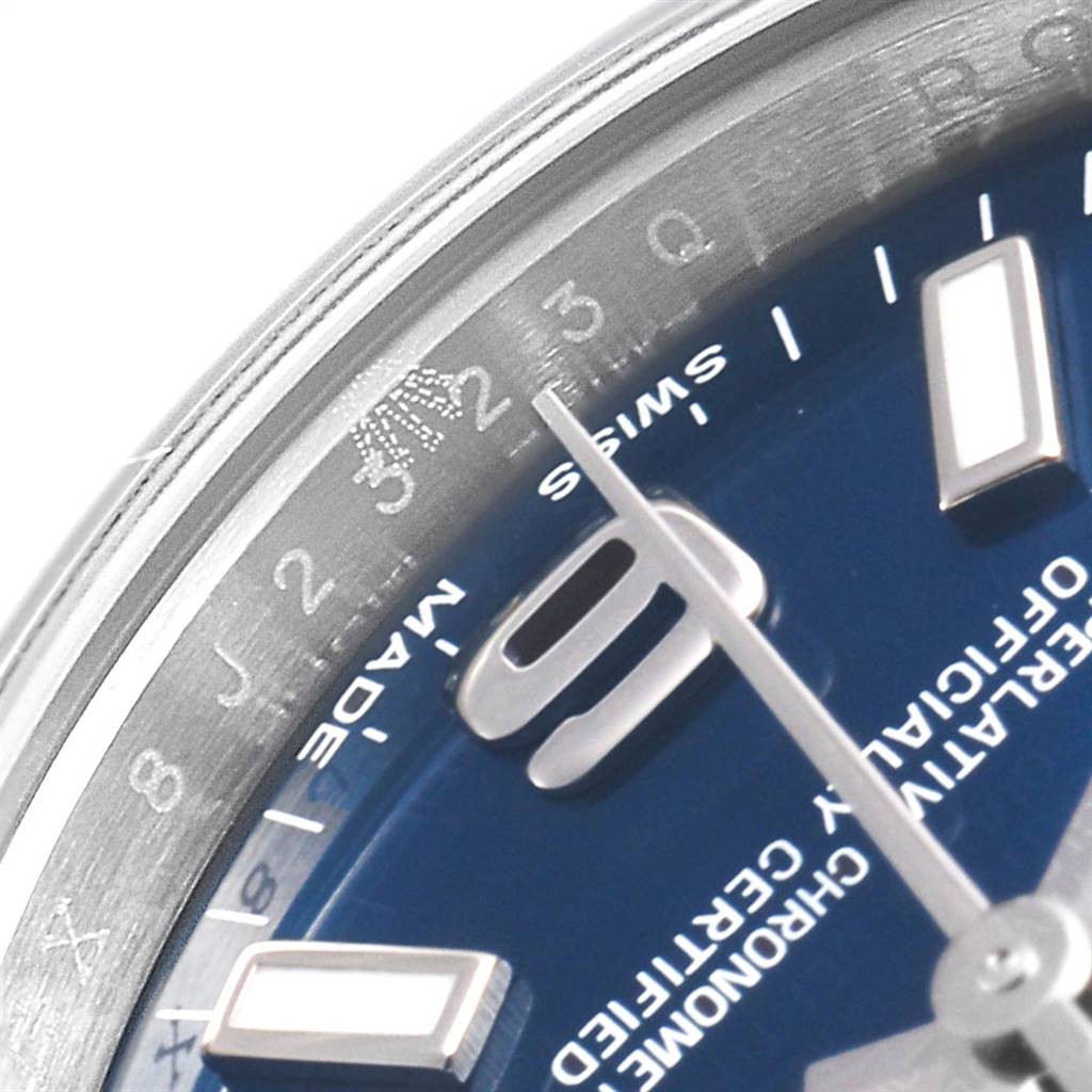 This close-up image shows part of the dial, hands, and the engraved bezel of the Rolex Oyster Perpetual 176200 Women's Stainless Steel Blue Dial 176200 Women's Stainless Steel Blue Dial watch.