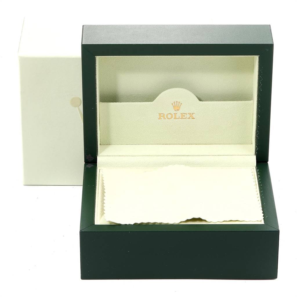 The image shows an open green and beige Rolex watch box for the Oyster Perpetual model.