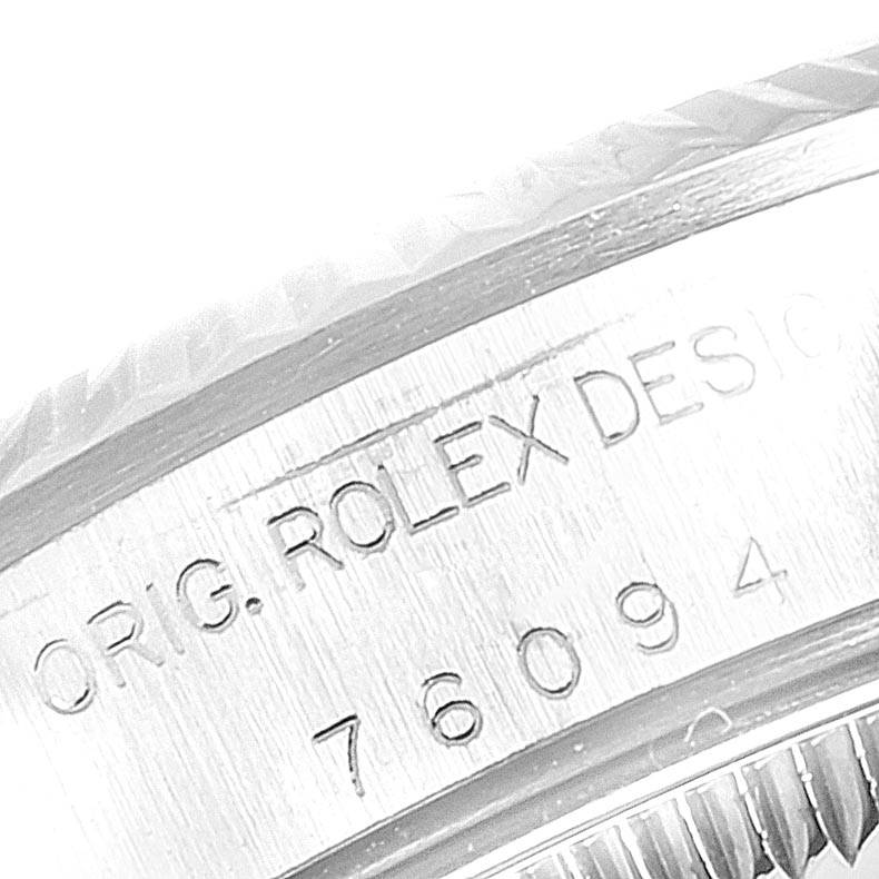 This image shows a close-up of the case side and serial number of a Rolex Oyster Perpetual 76094 Women
s Stainless Steel White Dial 76094 Women
s Stainless Steel White Dial watch.