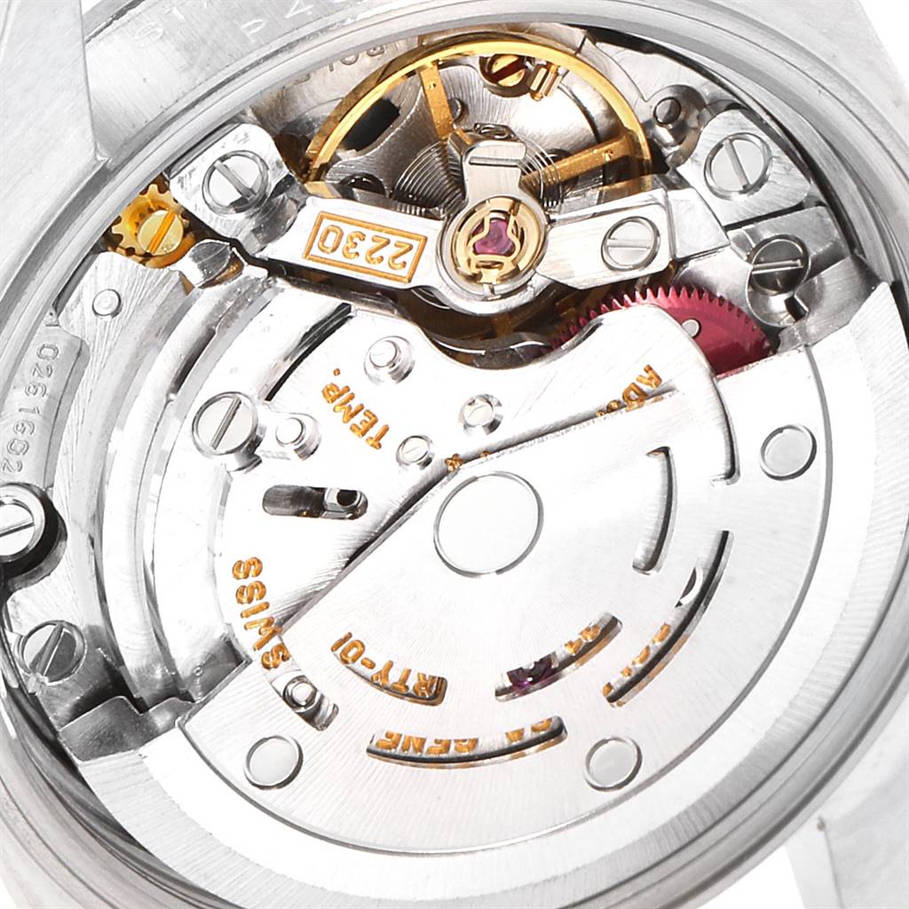 The image shows a close-up of the movement mechanism of a Rolex Oyster Perpetual 76094 Women
s Stainless Steel White Dial 76094 Women
s Stainless Steel White Dial watch, revealing intricate components.