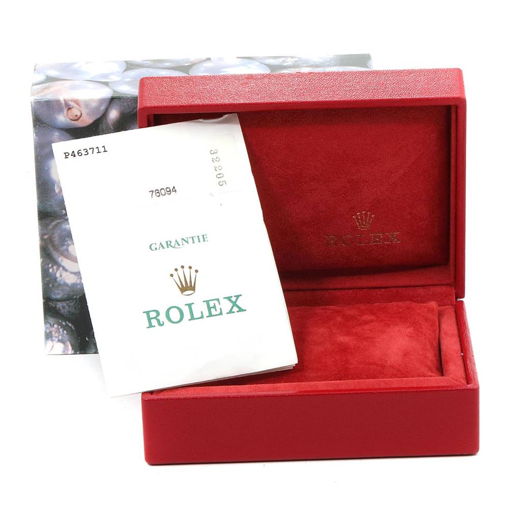 The image shows a red Rolex watch box for the Oyster Perpetual model with a warranty card partially inside.