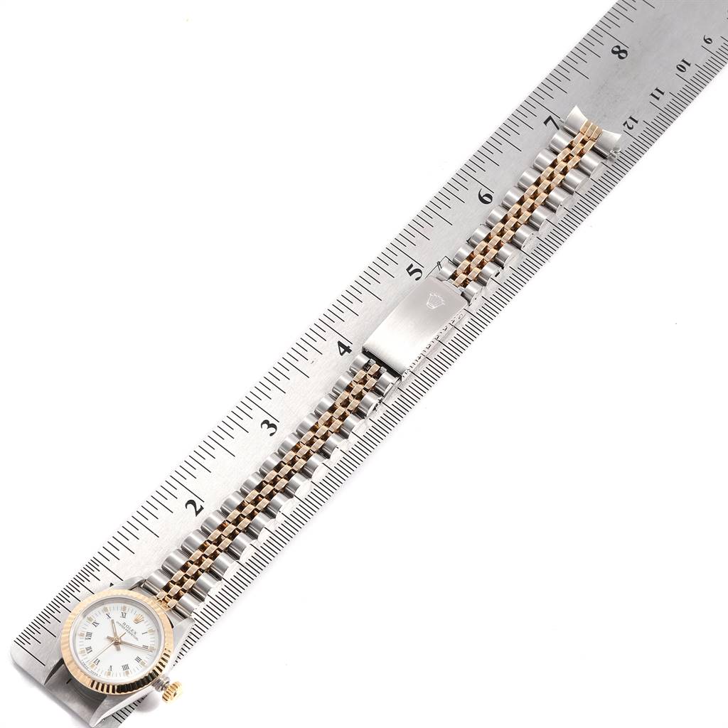 The Rolex Oyster Perpetual 67193 Women
s Steel and Gold (two tone) White Dial 67193 Women
s Steel and Gold (two tone) White Dial watch is shown face-up with its bracelet measured against a ruler.