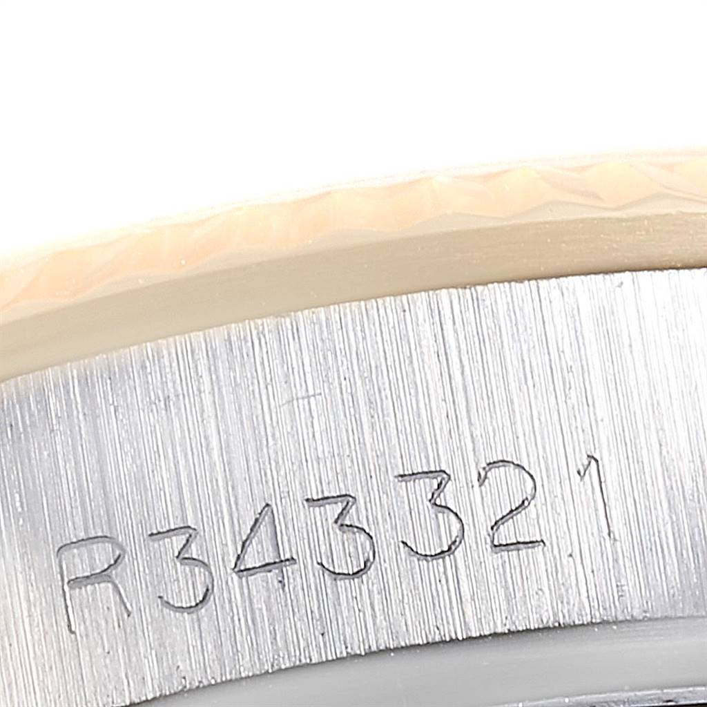 This close-up image shows the serial number engraving on the bezel of a Rolex Oyster Perpetual 67193 Women
s Steel and Gold (two tone) White Dial 67193 Women
s Steel and Gold (two tone) White Dial watch.