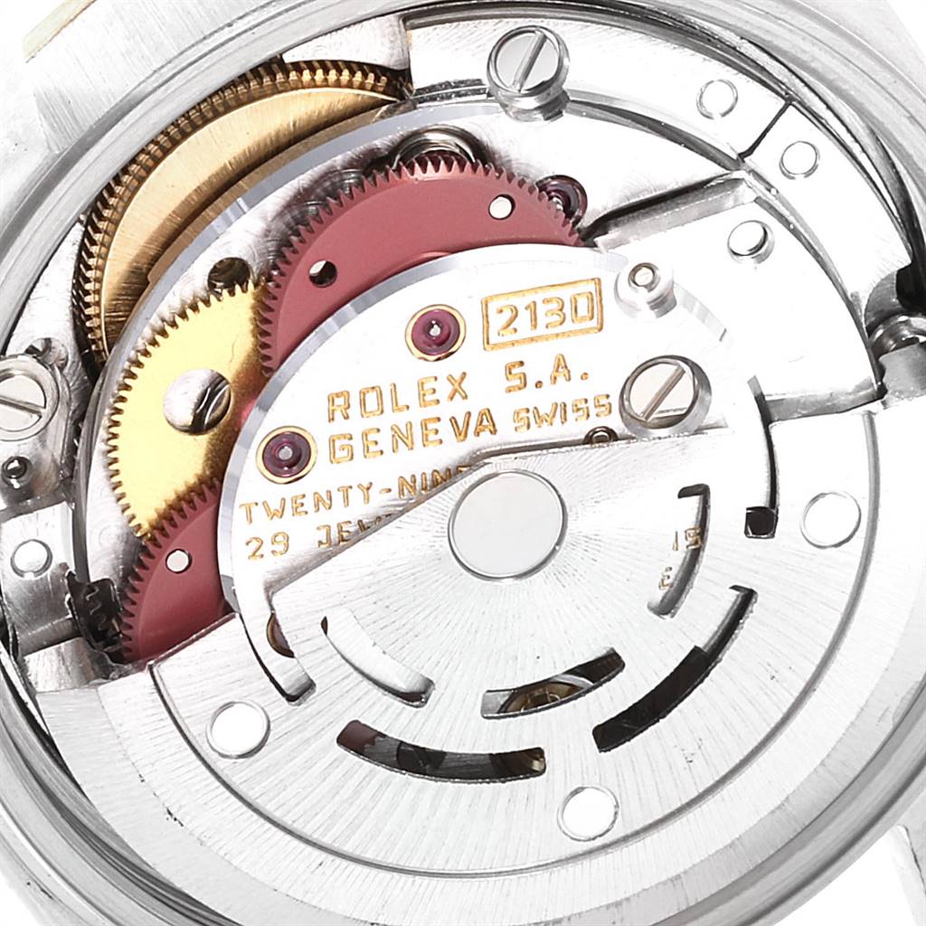 This is a close-up of the movement of a Rolex Oyster Perpetual 67193 Women
s Steel and Gold (two tone) White Dial 67193 Women
s Steel and Gold (two tone) White Dial watch showing gears and other internal components.