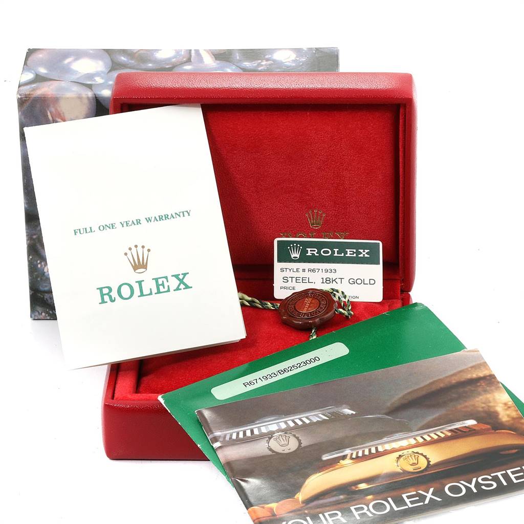 The image shows the accessories including the box, warranty card, and booklet for a Rolex Oyster Perpetual 67193 Women
s Steel and Gold (two tone) White Dial 67193 Women
s Steel and Gold (two tone) White Dial model.