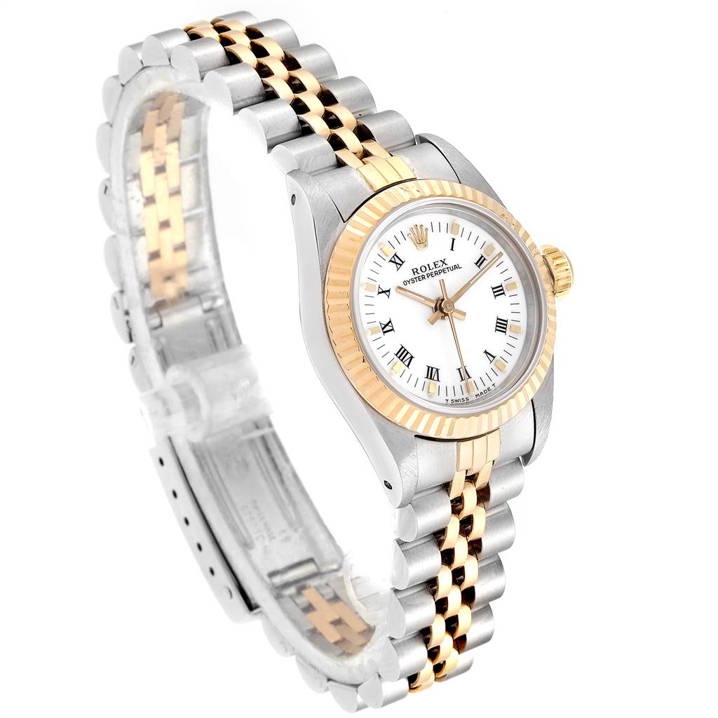 The Oyster Perpetual Rolex watch is shown at an angled side view, highlighting the face, bezel, crown, and bracelet.