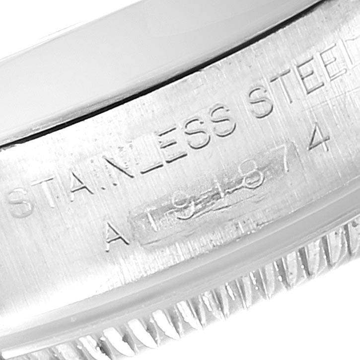 The image shows a close-up of the engraved stainless steel bezel of a Rolex Oyster Perpetual 76080 Women's Stainless Steel Black Dial 76080 Women's Stainless Steel Black Dial watch.