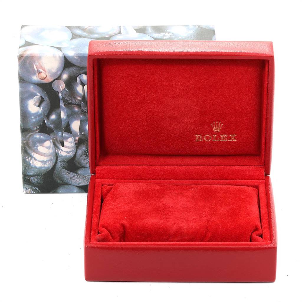The image shows an open red Rolex watch box for the Oyster Perpetual model with a cushion inside and the Rolex logo.