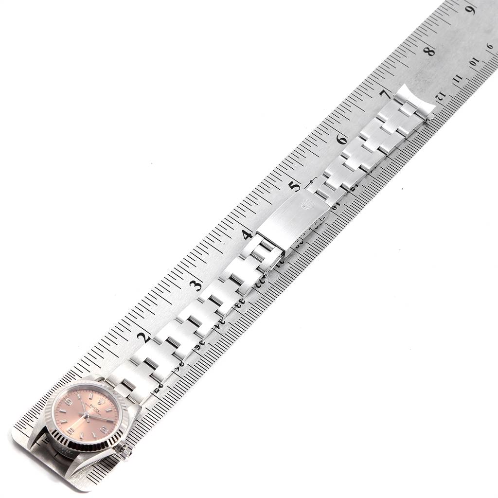 The image shows an overhead view of a Rolex Oyster Perpetual 67194 Women's Stainless Steel Pink Dial 67194 Women's Stainless Steel Pink Dial watch placed alongside a ruler, highlighting its bracelet length.