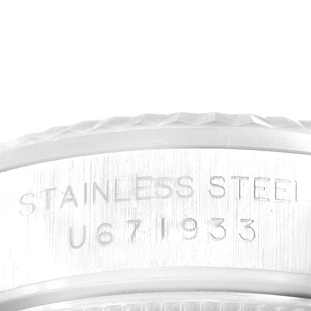 The image shows a close-up of the engraved stainless steel casing of a Rolex Oyster Perpetual 67194 Women's Stainless Steel Pink Dial 67194 Women's Stainless Steel Pink Dial watch.