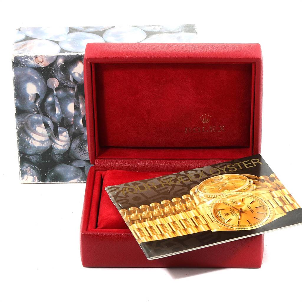The image shows a red Rolex watch box and a booklet for an Oyster Perpetual model, with the box lid open.