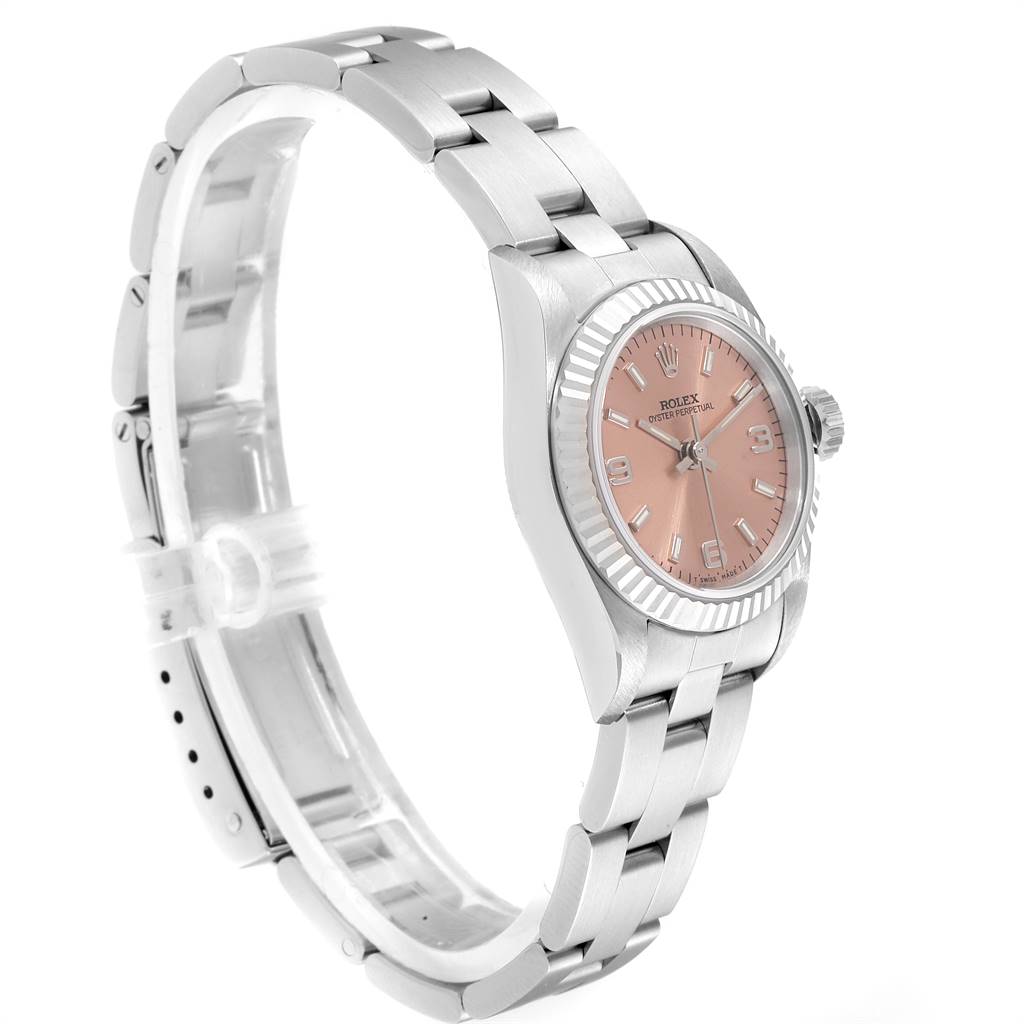 The Rolex Oyster Perpetual 67194 Women's Stainless Steel Pink Dial 67194 Women's Stainless Steel Pink Dial watch is shown from a side angle highlighting the bracelet, bezel, and dial.