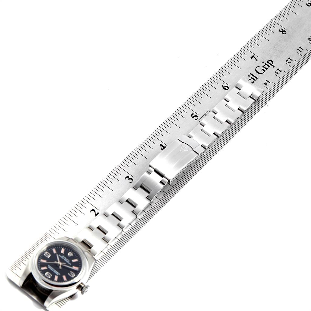 The image shows a Rolex Oyster Perpetual 176200 Women's Stainless Steel Black Dial 176200 Women's Stainless Steel Black Dial watch laid flat with a ruler beside it, displaying the watch face and bracelet.