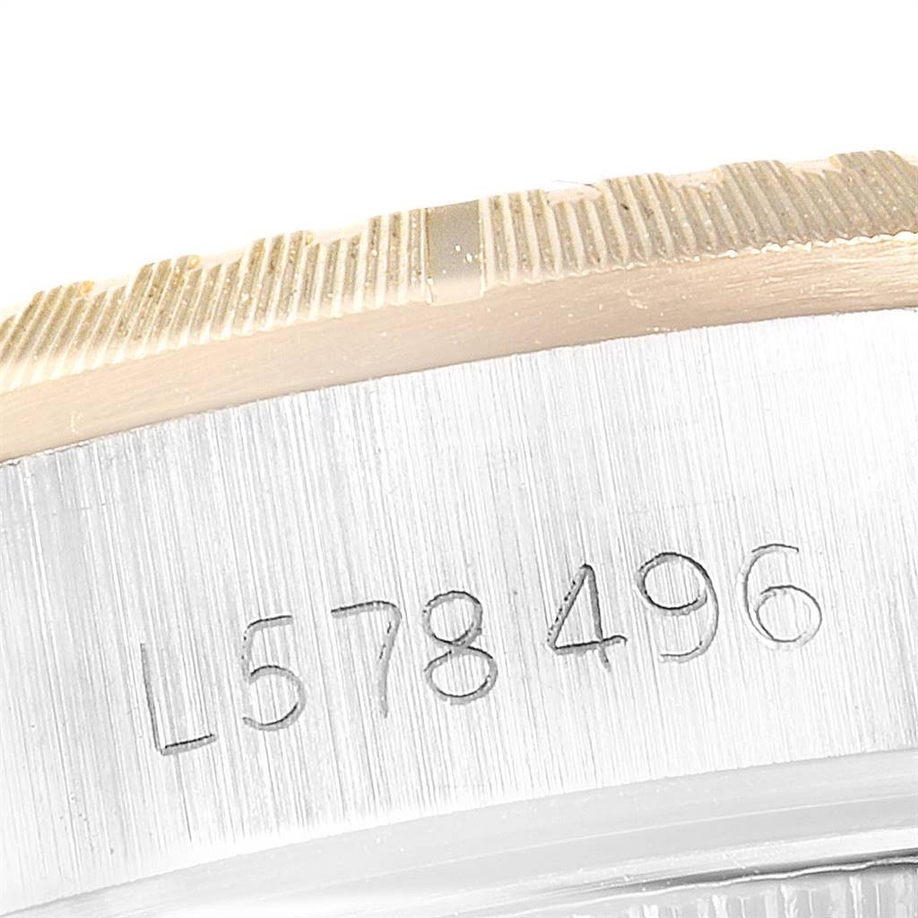 This image shows a close-up of the case side with the serial number on a Rolex Oyster Perpetual 67243 Women
s Steel and Gold (two tone) Champagne Dial 67243 Women
s Steel and Gold (two tone) Champagne Dial watch.