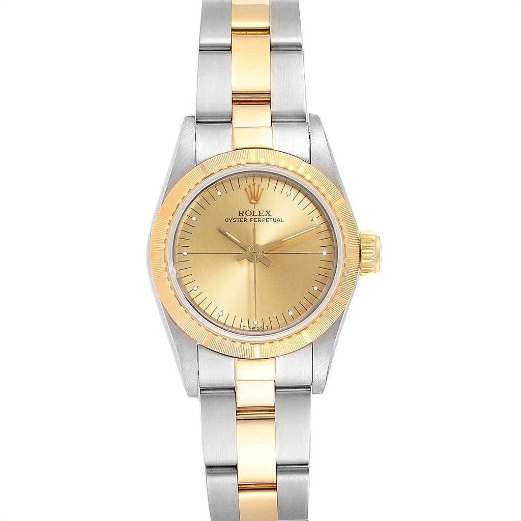 The image shows a Rolex Oyster Perpetual 67243 Women
s Steel and Gold (two tone) Champagne Dial 67243 Women
s Steel and Gold (two tone) Champagne Dial watch from a front view, highlighting its dial, bezel, and metal bracelet.