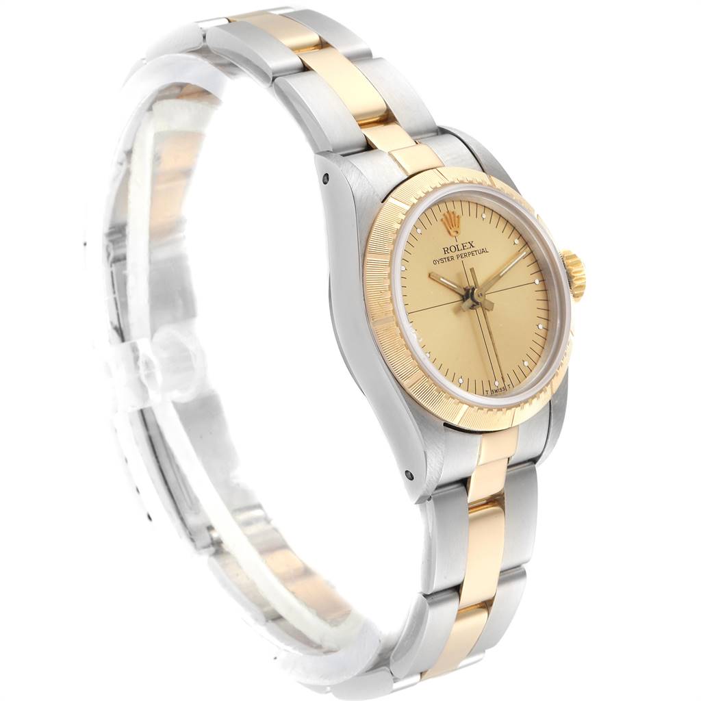 The image shows a Rolex Oyster Perpetual 67243 Women
s Steel and Gold (two tone) Champagne Dial 67243 Women
s Steel and Gold (two tone) Champagne Dial watch at a slight angle, highlighting the gold and silver bracelet, the beige dial, and the gold bezel.