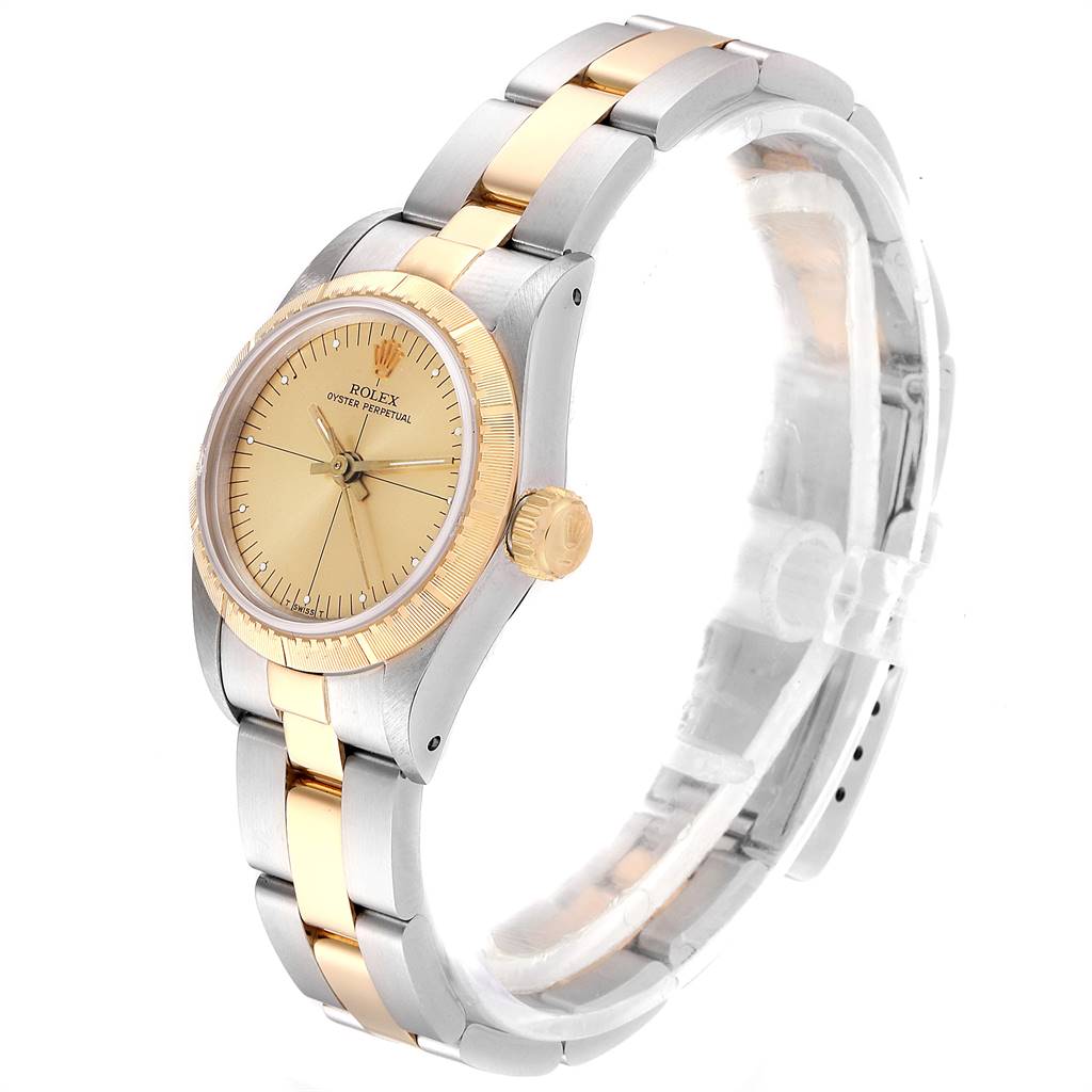 The Rolex Oyster Perpetual 67243 Women
s Steel and Gold (two tone) Champagne Dial 67243 Women
s Steel and Gold (two tone) Champagne Dial watch is shown at an angled side view, highlighting its gold and silver bracelet, bezel, and crown.