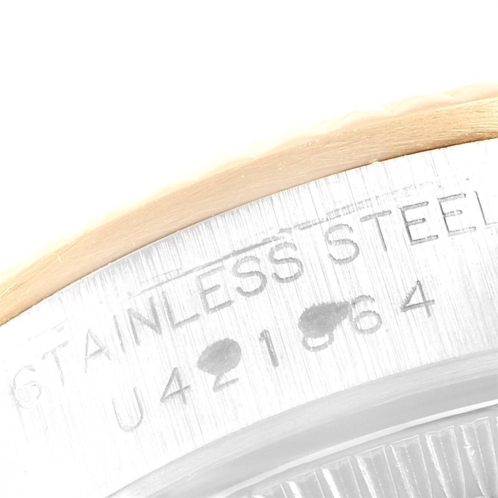 This close-up image shows the serial number engraving on the stainless steel case of a Rolex Oyster Perpetual 67193 Women
s Steel and Gold (two tone) Champagne Dial 67193 Women
s Steel and Gold (two tone) Champagne Dial watch.