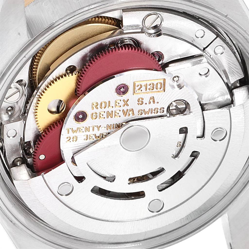 This image shows the internal mechanism of the Rolex Oyster Perpetual 67193 Women
s Steel and Gold (two tone) Champagne Dial 67193 Women
s Steel and Gold (two tone) Champagne Dial watch model, highlighting gears and movement components.