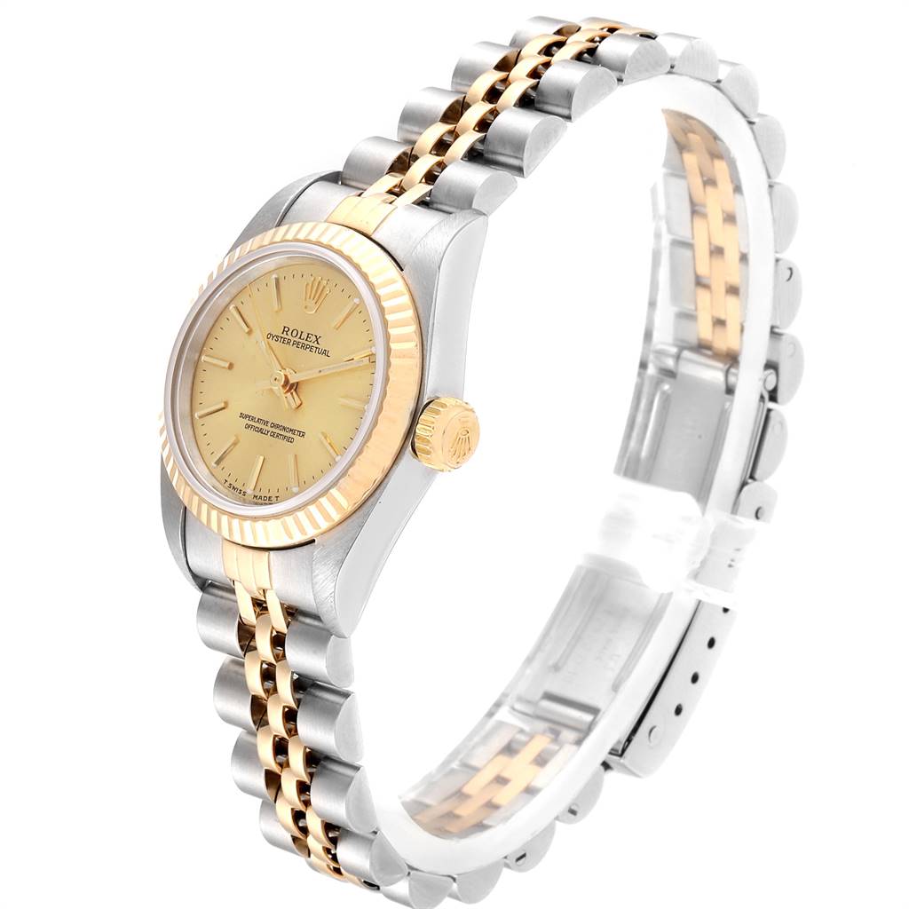 This image shows a side angle of a Rolex Oyster Perpetual 67193 Women
s Steel and Gold (two tone) Champagne Dial 67193 Women
s Steel and Gold (two tone) Champagne Dial watch featuring its dial, fluted bezel, crown, and two-tone bracelet.