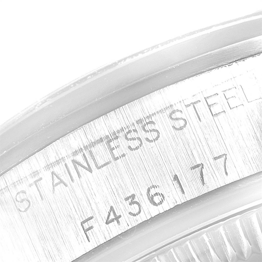 This close-up image shows the engraved text on the stainless steel case of a Rolex Oyster Perpetual 67180 Women's Stainless Steel Pink Dial 67180 Women's Stainless Steel Pink Dial watch.