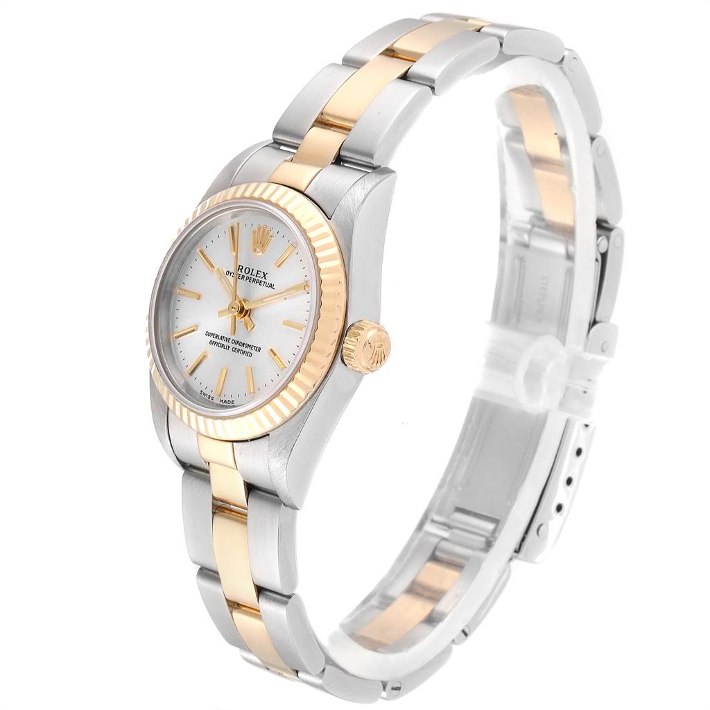 The image shows a side angle of the Rolex Oyster Perpetual 76193 Women's Steel and Gold (two tone) Silver Dial 76193 Women's Steel and Gold (two tone) Silver Dial watch, highlighting its gold and silver bracelet, crown, and dial.