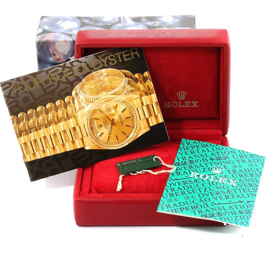 The image shows the packaging and accessories for a Rolex Oyster Perpetual 76193 Women's Steel and Gold (two tone) Silver Dial 76193 Women's Steel and Gold (two tone) Silver Dial watch, including the box, manuals, and tags.