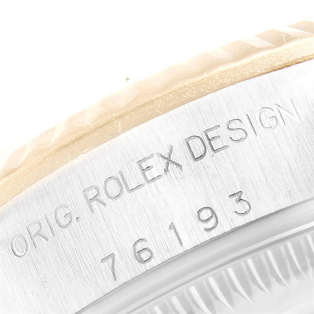 This image shows a close-up of the side of a Rolex Oyster Perpetual 76193 Women's Steel and Gold (two tone) Silver Dial 76193 Women's Steel and Gold (two tone) Silver Dial watch, highlighting the engraved "ORIG. ROLEX DESIGN" and model number.